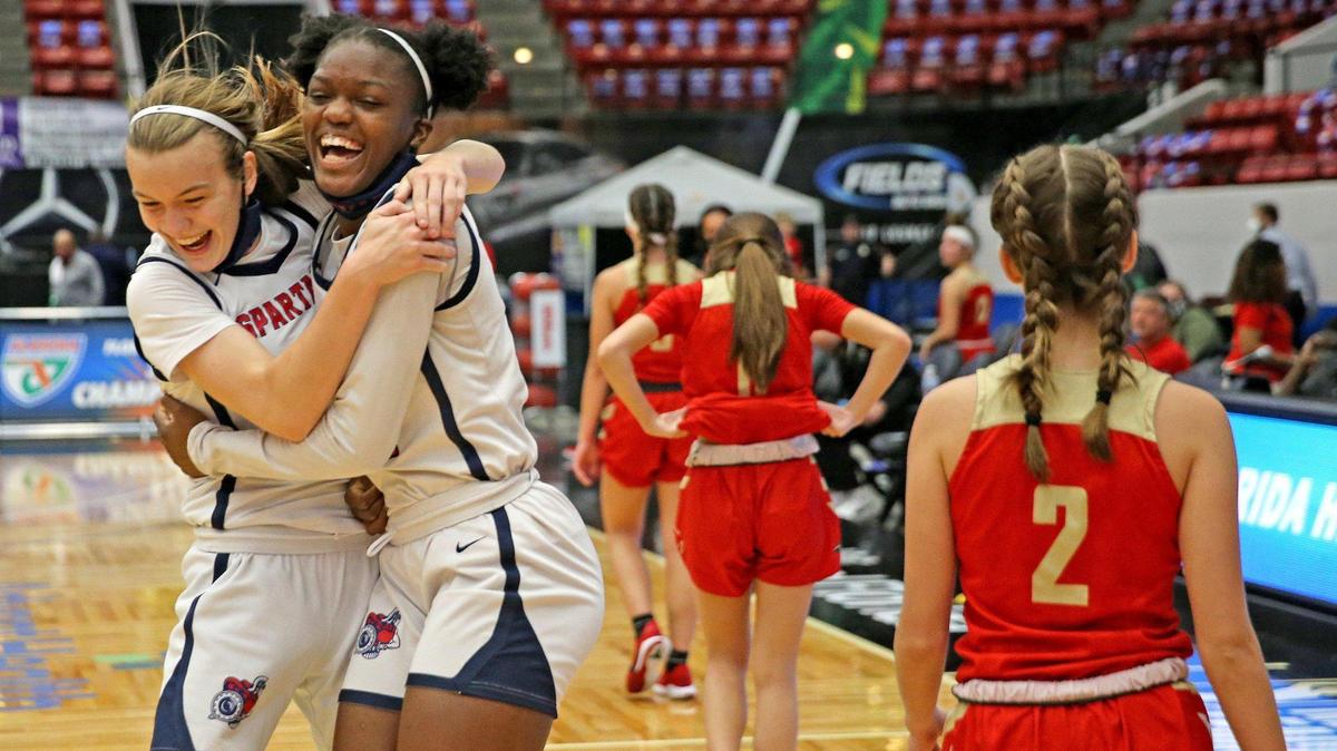 Miami Country Day Kristina Godfrey (3) and Andrea Daley (21) celebrate as they defeat Cardinal Mooney in the FHSAA 3A Girl’s Basketball Finals in Lakeland, Florida, Friday, March 5, 2021.