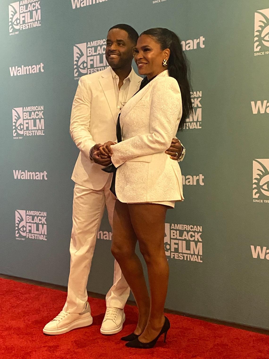 Nia Long and Larenz Tate pose for photos inside a media room at the American Black Film Festival ahead of their conversation about their movie Love Jones.