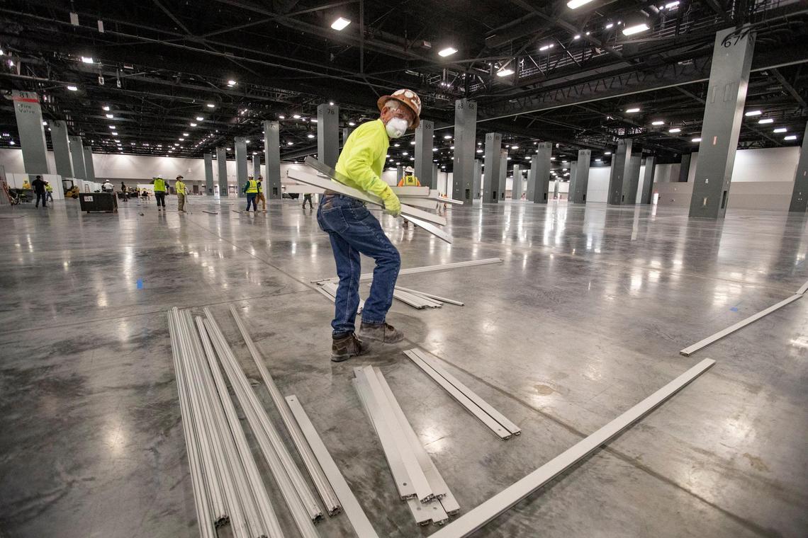 Representatives from the Army Corp of Engineers, trade contractors and employees from Robins & Morton build a coronavirus field hospital inside the Miami Beach Convention Center on Wednesday, April 8, 2020.