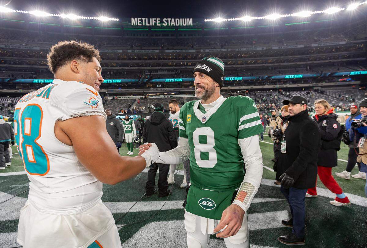 Miami Dolphins defensive end Matt Dickerson (98) shakes hands with New York Jets quarterback Aaron Rodgers (8) after their NFL game at the MetLife Stadium on Sunday, Jan. 5, 2025, in East Rutherford, N.J.