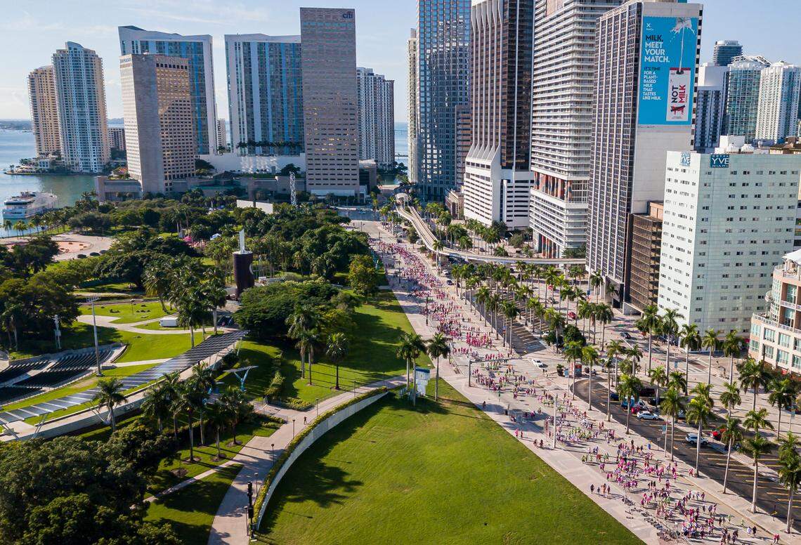 Participants make their way down Biscayne Boulevard during the Susan G. Komen More Than Pink Walk in downtown Miami on Saturday, October 16, 2021.