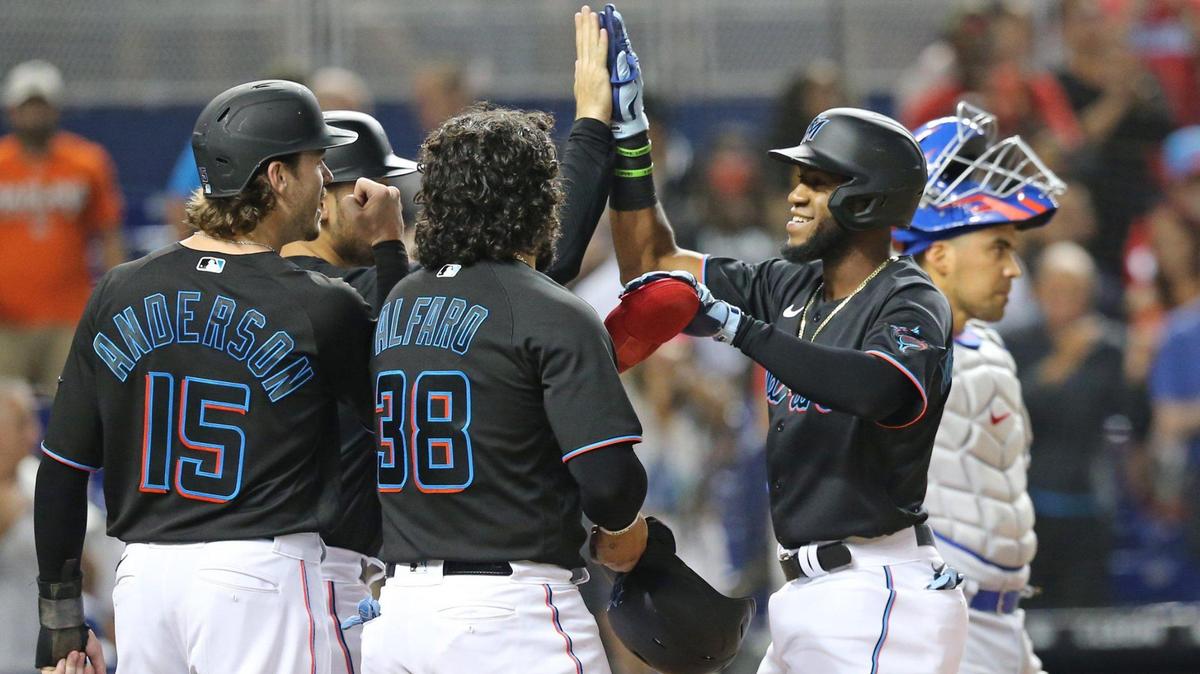 Miami Marlins right fielder Bryan De La Cruz (77) celebrates at homeplate after hitting a grand slam in the second inning against the Chicago Cubs during baseball game at loanDepotPark in Miami on Friday, August 13, 2021.