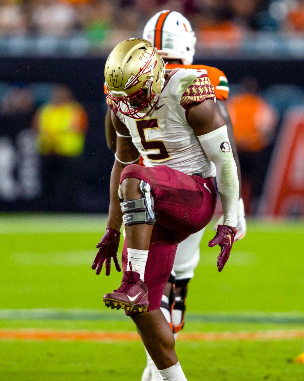 Florida State University defensive end Jared Verse (5) motions as if ‘snapping the U’ after sacking University of Miami quarterback Jacurri Brown (11) during the first half of an ACC football game at Hard Rock Stadium in Miami Gardens on Saturday, November 5, 2022.