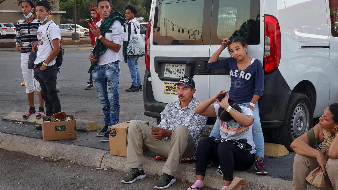 Venezuelan migrants who recently crossed the southern U.S. border with Mexico, sit near San Antonio’s shelter, waiting for offers of work or buses out of town.