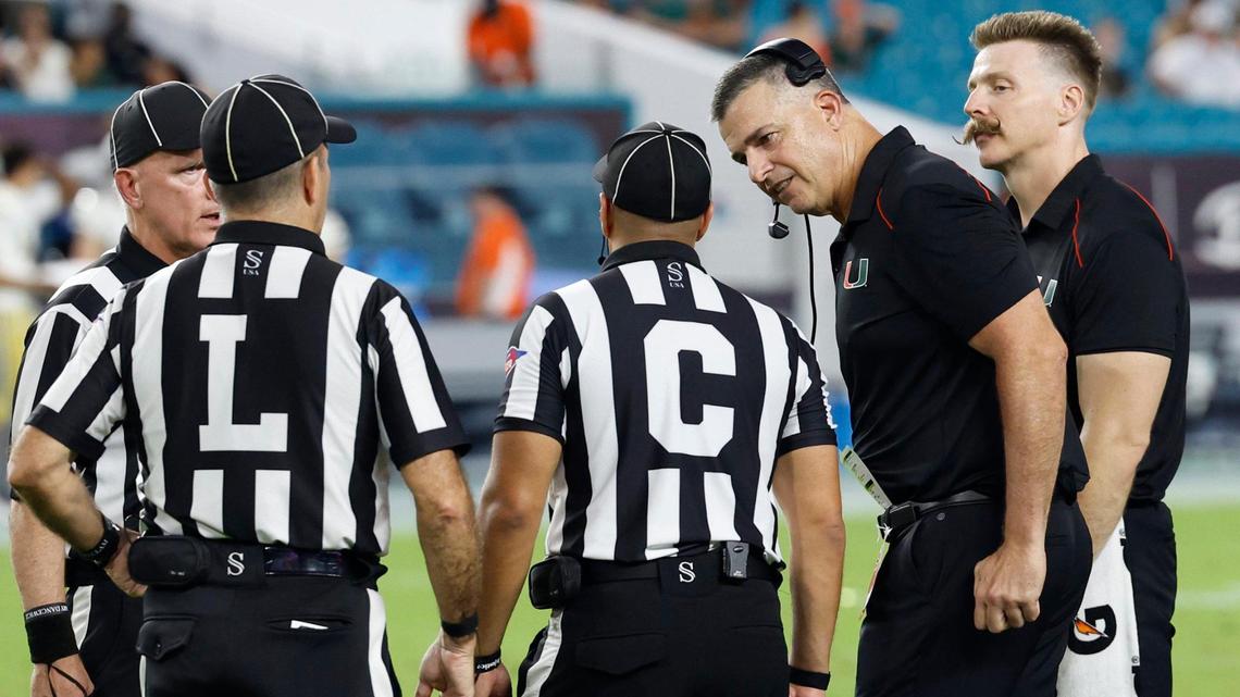 Miami Hurricanes head coach Mario Cristobal argues with the officials during the review of the play of running back Donald Chaney Jr. (2) that game officials called a fumble and recovered by Georgia Tech Yellow Jackets defensive lineman Kyle Kennard (9) late in the fourth quarter at Hard Rock Stadium in Miami Gardens on Saturday, October 7, 2023.