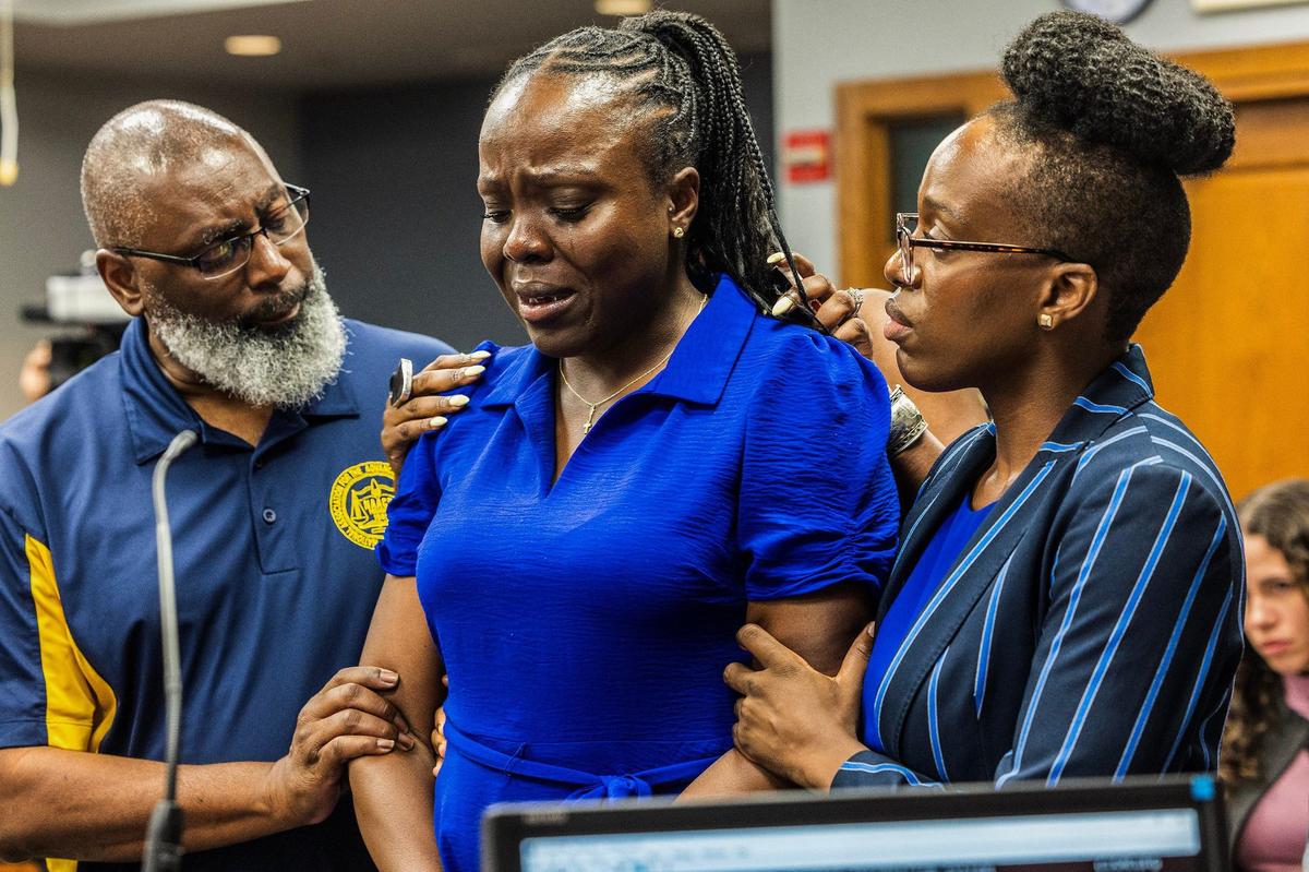 Harold Ford, with the NAACP South Dade branch, left, and Merilynn Etienne, far right, comforts her sister Keisha Etienne, center, as she cries during Albert Bassett plea hearing at the Gerstein Justice Building in Miami on Tuesday, May 28, 2024.