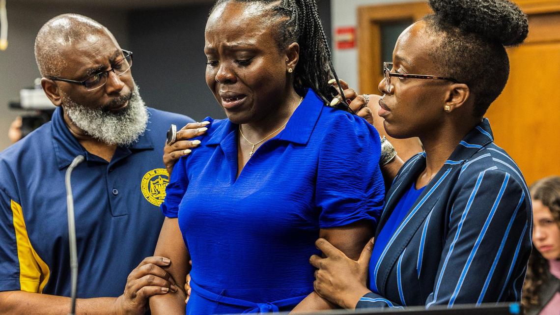 Harold Ford, with the NAACP South Dade Branch, and Merilynn Etienne, far right, comforts her sister Keisha Etienne, center, as she cries during Albert Bassett plea hearing at the Gerstein Justice Building in Miami on Tuesday, May 28, 2024. Bassett was previously charged with four counts of sexual battery on a minor and three counts of lewd and lascivious conduct.