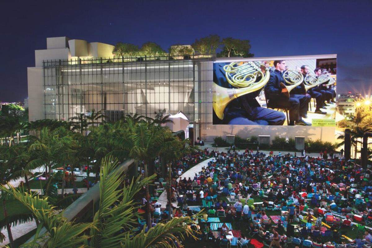 New World Symphony Wallcast concert. Inside, Fellows perform; outside, Soundscape Park becomes a public square where Miami gathers around music.