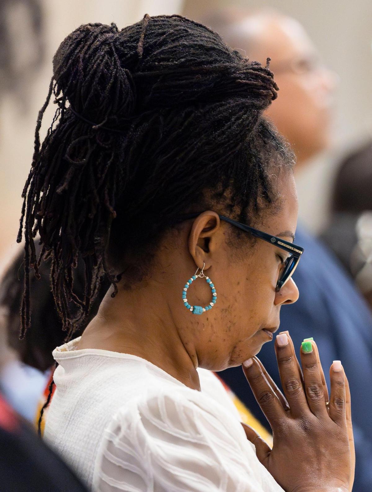 Nadine Maignan, 56, prays during a Good Friday service at the Cathedral of St. Mary on Friday, April 18, 2025, in Miami, Fla.
