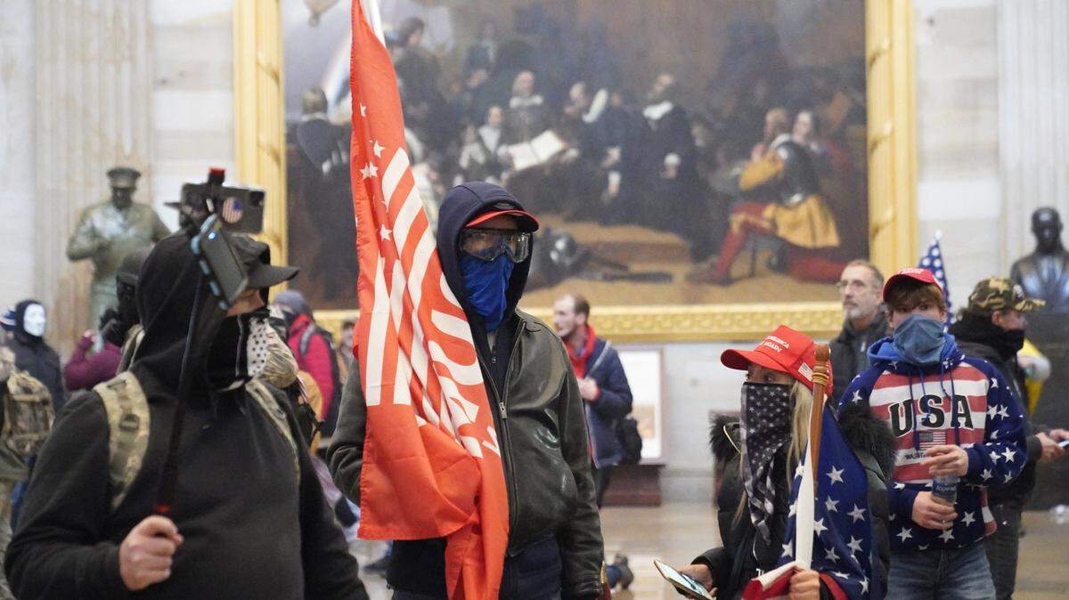 Protestors enter the Capitol building during a joint session of Congress in Washington, DC on Wednesday, January 6, 2021. The joint session of the House and Senate was sent to recess after the breach as it convened to confirm the Electoral College votes cast in November’s election.