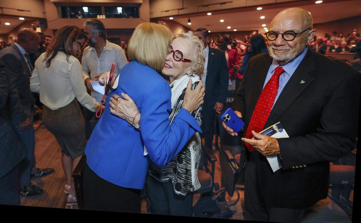 The parents of Eileen Higgins, Patricia and Cornelius, greet their daughter on arrival for the installation ceremony as the Mayor of the City of Miami at the Miami-Dade College Wolfson Campus Auditorium in Miami, Florida, on Thursday, December 18, 2025. 