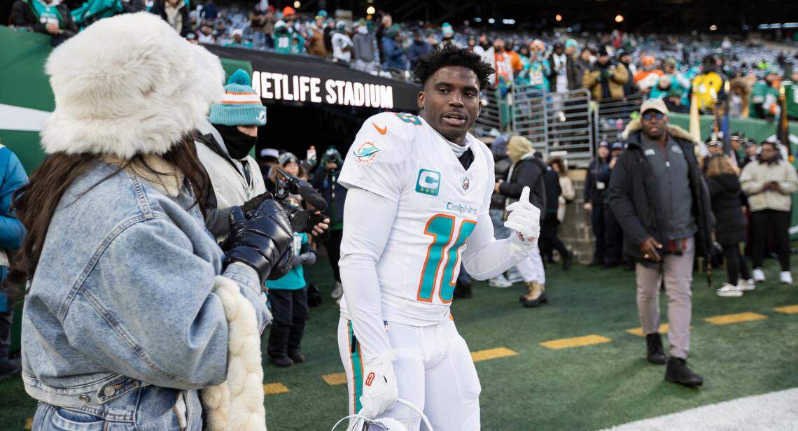 Miami Dolphins wide receiver Tyreek Hill (10) talks with his wife, Keeta Vaccaro, before the start of his NFL game against the New York Jets at MetLife Stadium on Sunday, Jan. 5, 2025, in East Rutherford, N.J.