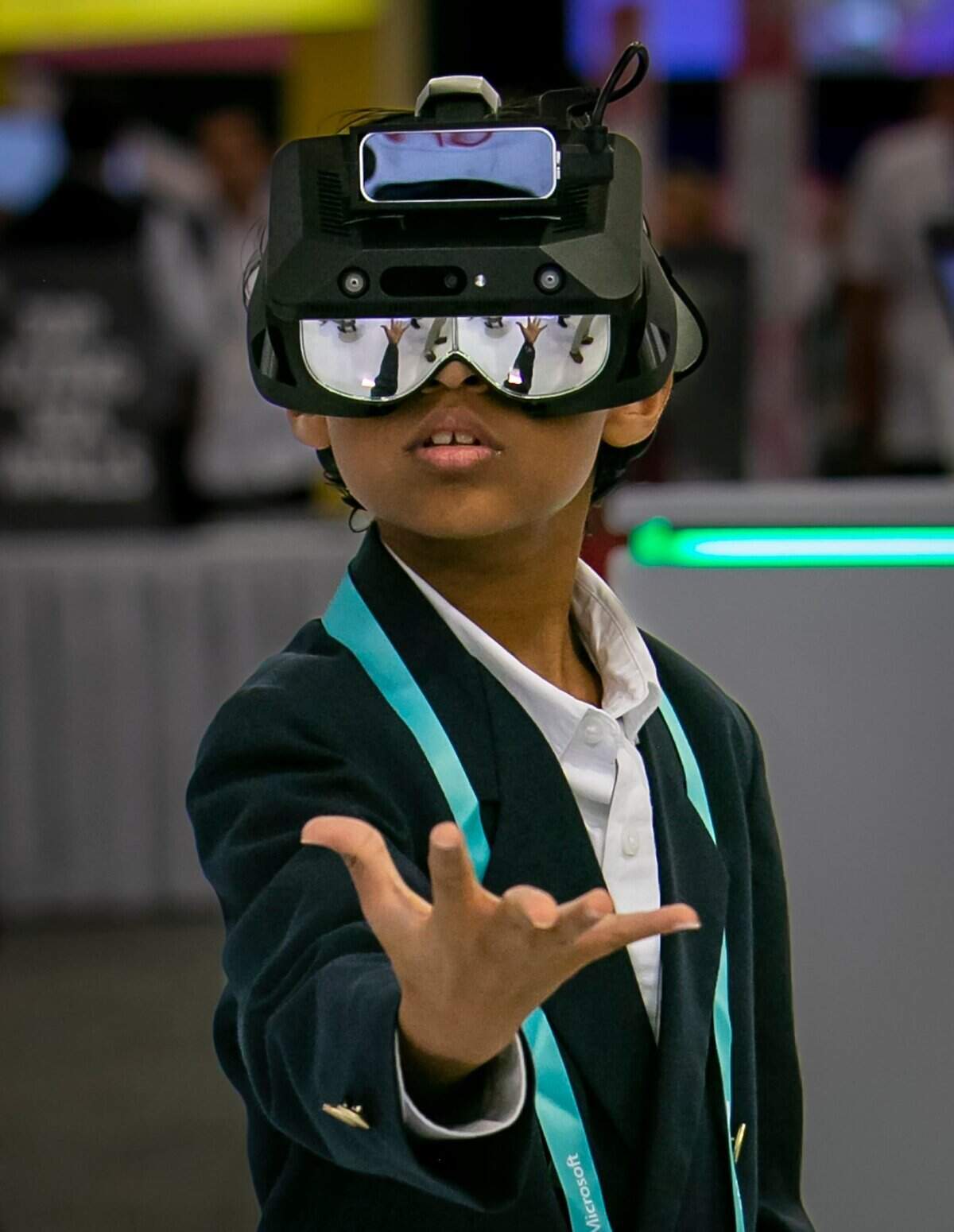 Nine-year-old Kai Kihei plays with a VR headset in the University of Miami booth at eMerge Americas 2023 at the Miami Beach Convention Center in Miami Beach, Florida, on Thursday, April 20, 2023.