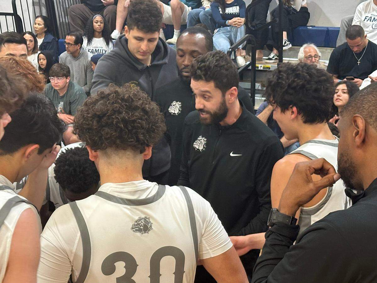 Riviera Prep coach Anthony Shahbaz talks to his team during a timeout in Monday’s Region 4-2A semifinal against Fort Lauderdale Westminster Academy at the Bulldogs’ gym.