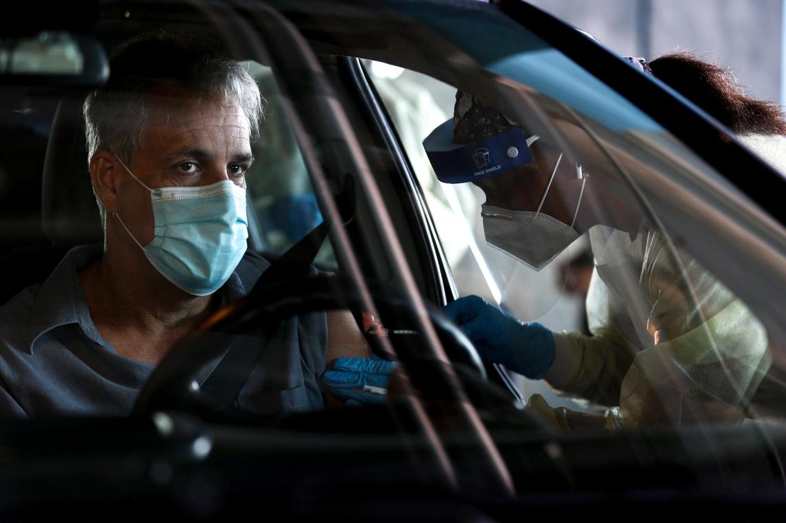 Andrew Garcia, an employee at Royal Caribbean, gets a shot of a COVID-19 vaccine at a county pop-up vaccination site at PortMiami Terminal A on Wednesday, April 28, 2021.