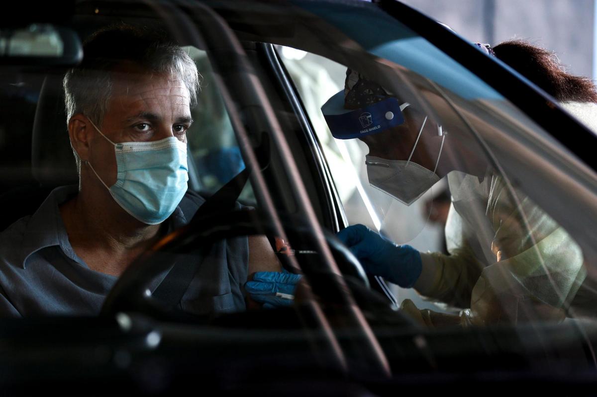 Andrew Garcia, an employee at Royal Caribbean, gets a shot of a COVID-19 vaccine at a county pop-up vaccination site at PortMiami Terminal A on Wednesday, April 28, 2021.