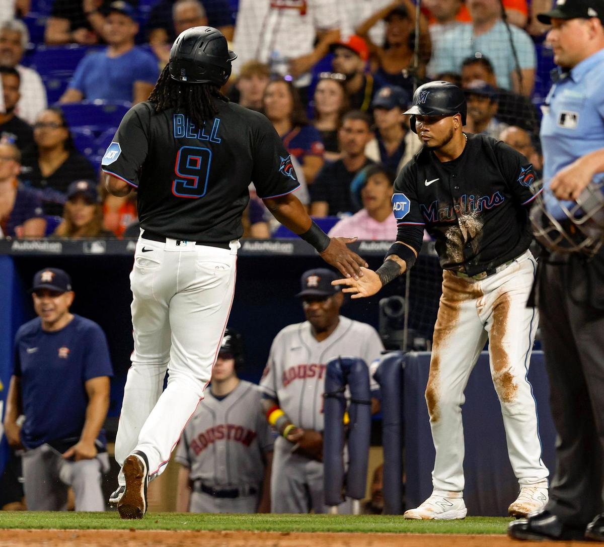 Miami Marlins first baseman Josh Bell (9) and Miami Marlins second baseman Luis Arraez (3) celebrate at home plate after scoring in the first inning against the Houston Astros at loanDepot park in Miami on Wednesday, August 16, 2023.