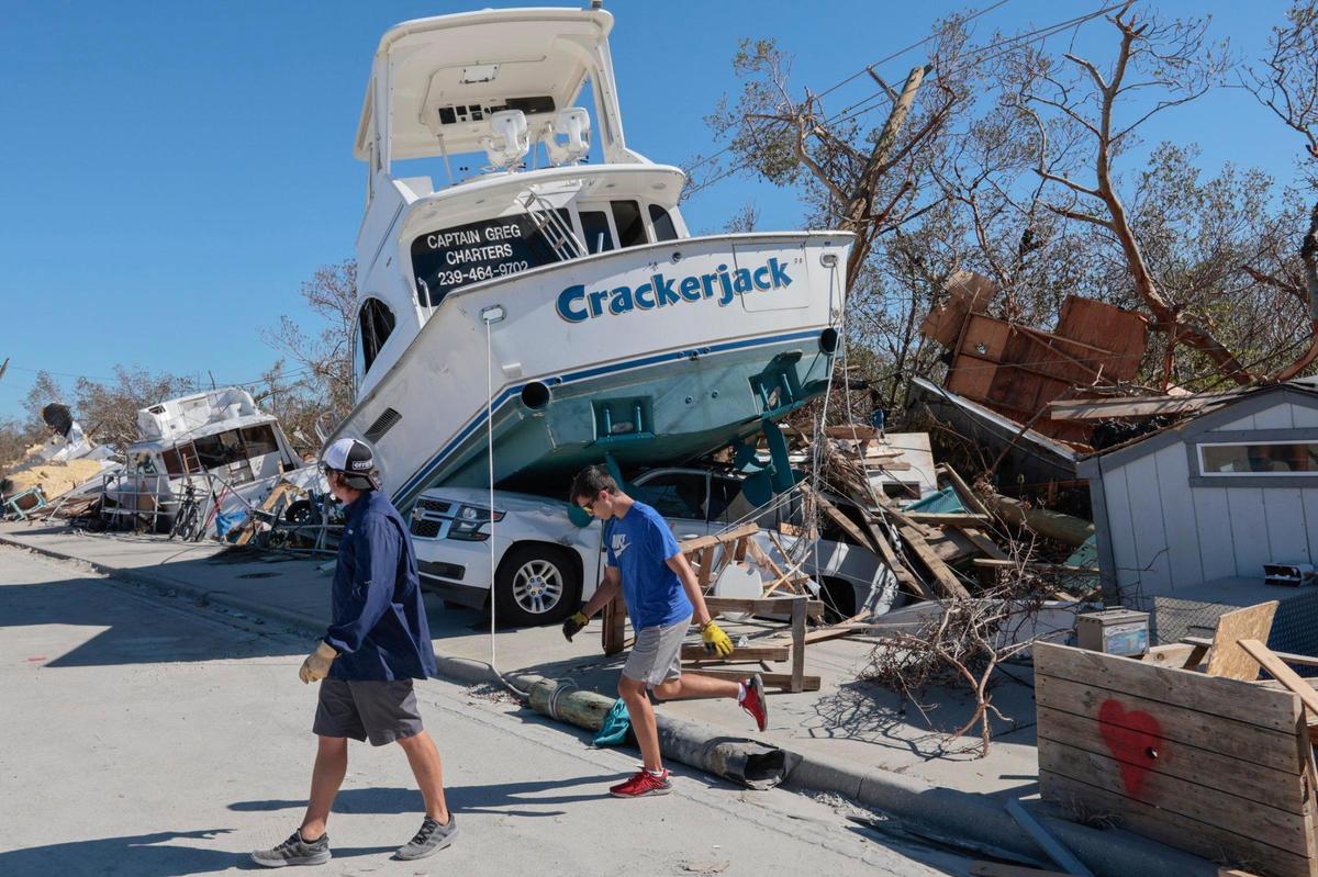 The charter boat Crackerjack sits on top of a car on San Carlos Island on Oct. 3, 2022, after Hurricane Ian.