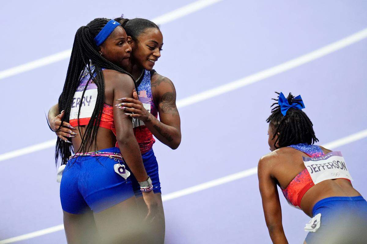Aug 3, 2024; Paris Saint-Denis, France; Sha’carri Richardson (USA) with Twanisha Terry (USA) and Melissa Jefferson (USA) after the womens 100m final during the Paris 2024 Olympic Summer Games at Stade de France. Mandatory Credit: Andrew Nelles-USA TODAY Sports
