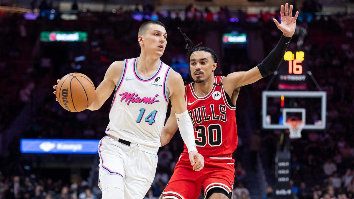Miami Heat guard Tyler Herro (14) drives the ball as Chicago Bulls guard Tre Jones (30) defends in the second half of their NBA game at Kaseya Center on March 8, 2025, in Miami.