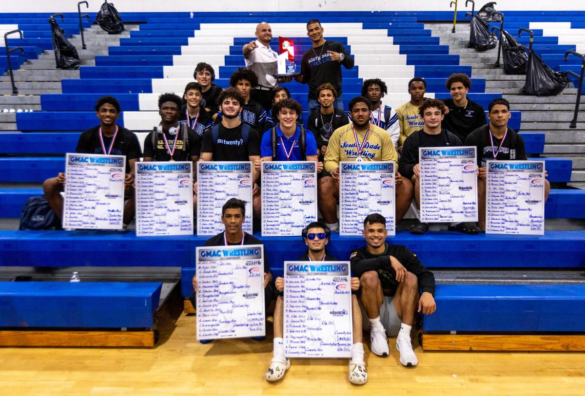 South Dade Senior High School Boys Wrestling Team poses with the 2023 Boys GMAC Wrestling Championship trophy at South Dade Senior High School in Homestead, Florida, on Saturday, February 4, 2023.