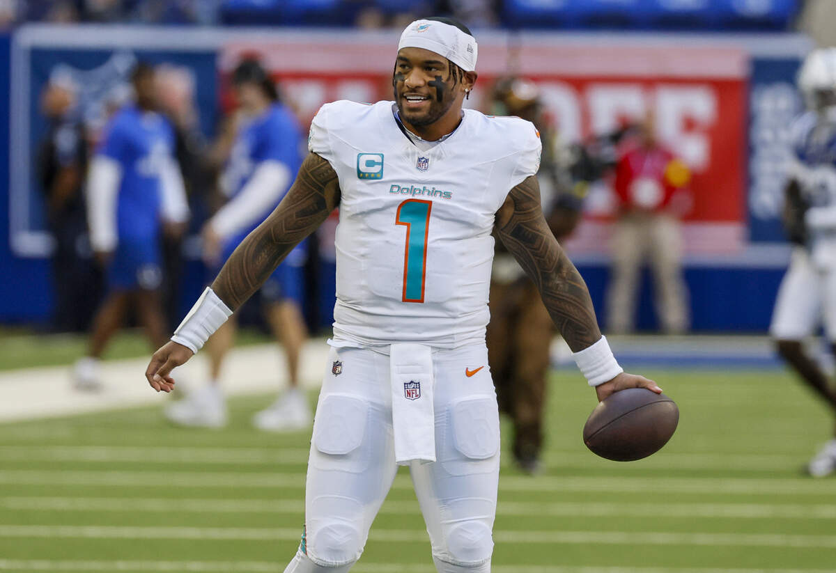 Miami Dolphins quarterback Tua Tagovailoa (1) warms up before an NFL game against the Indianapolis Colts at Lucas Oil Stadium on Sunday, Sept. 7, 2025, in Indianapolis.