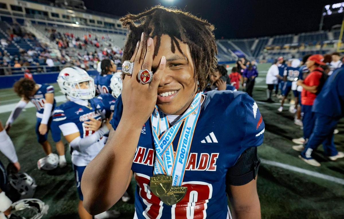 Chaminade-Madonna’s Donta Simpson (90) holds up his State Championship rings as he celebrates with teammates after defeating Clearwater Central Catholic in the Florida High School Football State Championships - Class 1A game at Pitbull Stadium on the campus of Florida International University in Miami, Florida, on Wednesday, December 11, 2024.