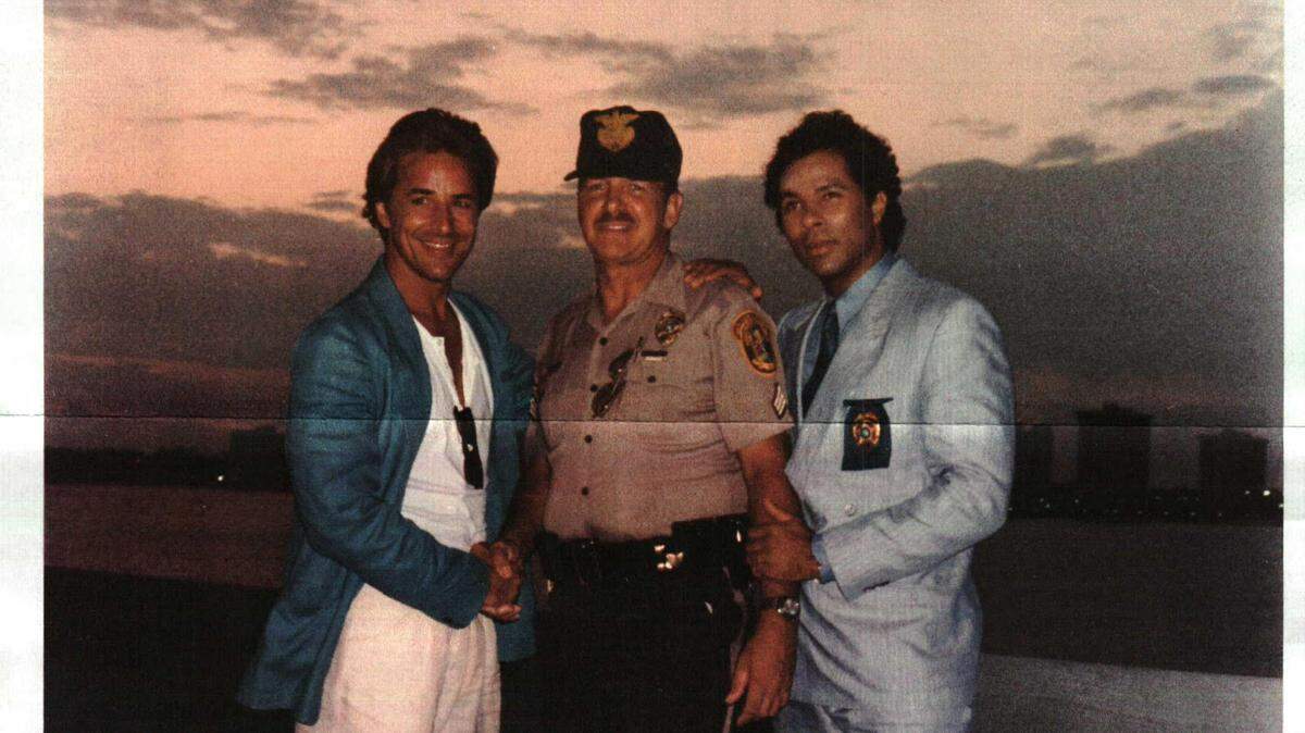 Robert Hoelscher, seen here between “Miami Vice” stars Don Johnson and Philip Michael Thomas, passed away last week after a 50-year career with Miami-Dade Police. He spent time working movie sets and consulting on the TV show that put Miami policing on the map.