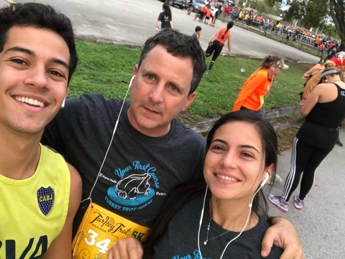 Martin Langesfeld and Nicole Langesfeld are shown with their father, Pablo Langesfeld, center, after running the 5K Turkey Trot.