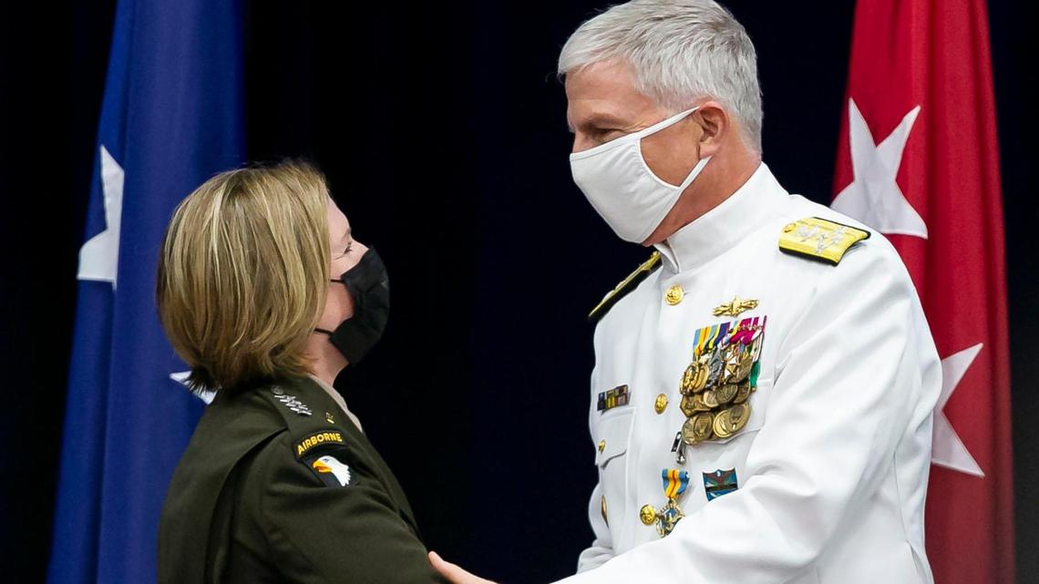The outgoing head of the U.S. Southern Command, Navy  Adm. Craig S. Faller, shakes hands with the new incoming commander, Army Gen. Laura J. Richardson, during a change-of-command ceremony at U.S. Southern Command in Doral, Florida, on Friday, Oct. 29, 2021.