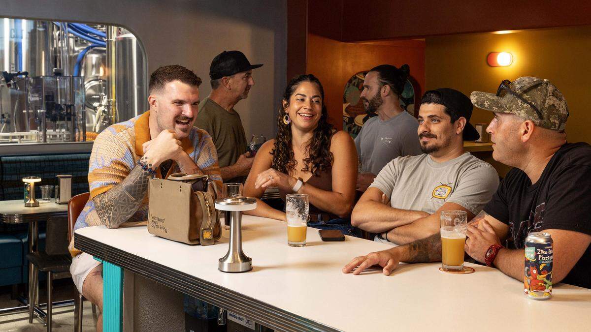 Form left to right, Ericn Zulewski, 34, Alexandra Zulewski , 34, Raul Serafin, 41, and Jonathan Gillen, 51, drink and socialize inside Rocketeer Beer & Liquid Provisions on Monday, October 13, 2025, in Miami, Fla.