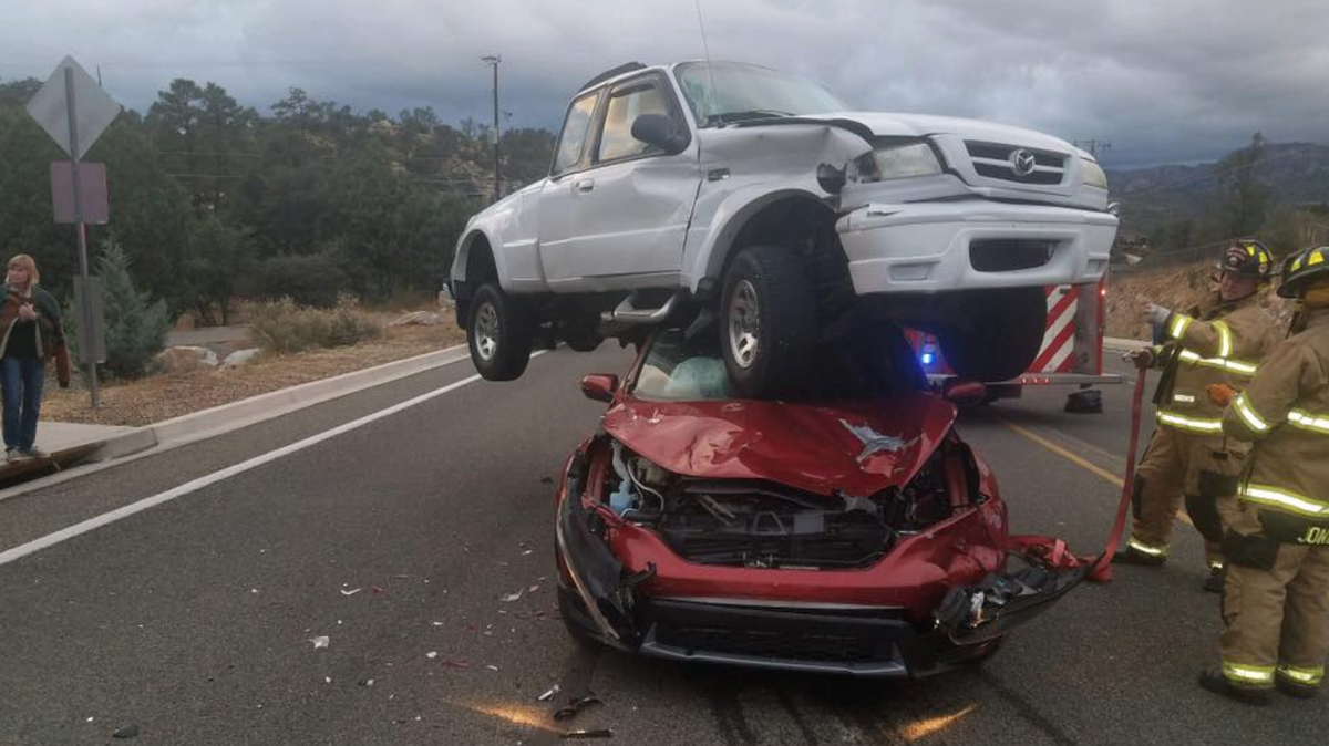 A crash captured on photographs in Yavapai County, Arizona, shows a truck on top of a car — but no one was injured because everyone inside had been wearing seatbelts, police say.