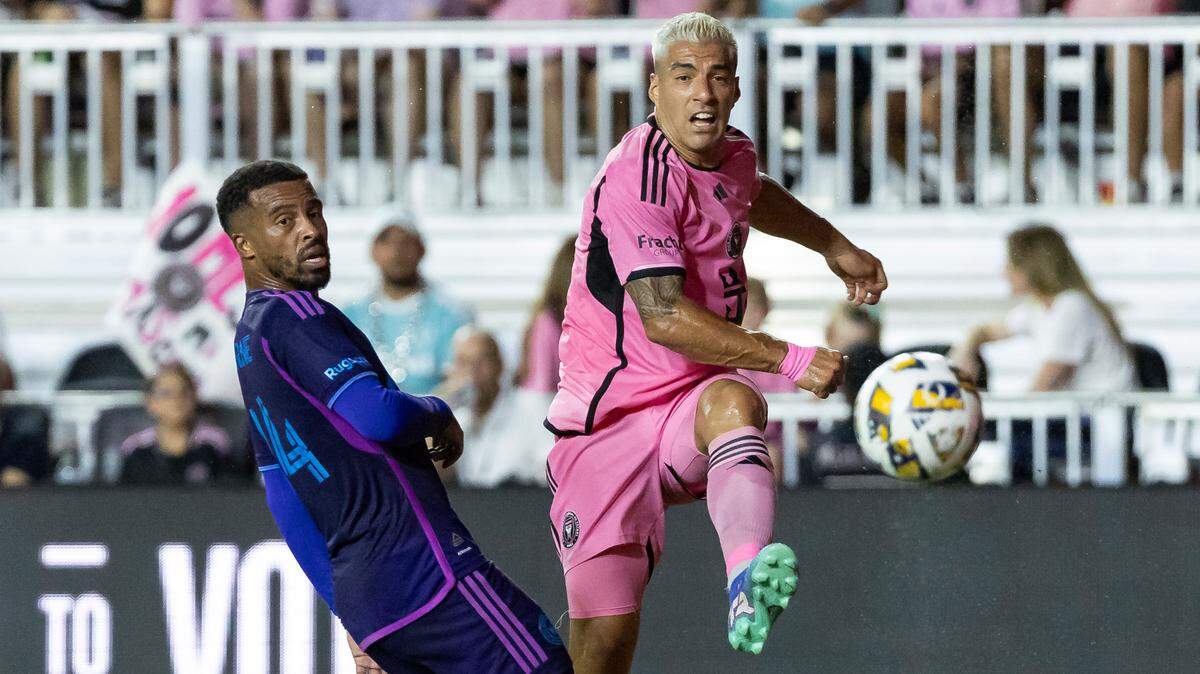 Inter Miami forward Luis Suárez (9) kicks the ball as Charlotte FC defender Nathan Byrne (14) defends in the first half of their MLS match at Chase Stadium on Saturday, Sept. 28, 2024, in Fort Lauderdale, Fla.