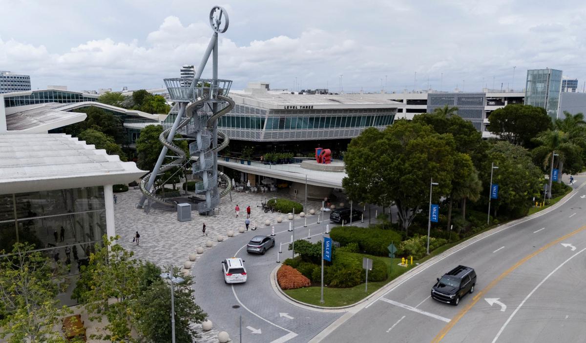 An aerial view of Carsten Höller’s 93-foot glass-and-steel slide, and Robert Indiana’s “Love” sculpture on the morning of Wednesday, Sept. 25, 2024. The visual welcomes visitors to Aventura Mall, one of the largest and most popular shopping centers in the United States.