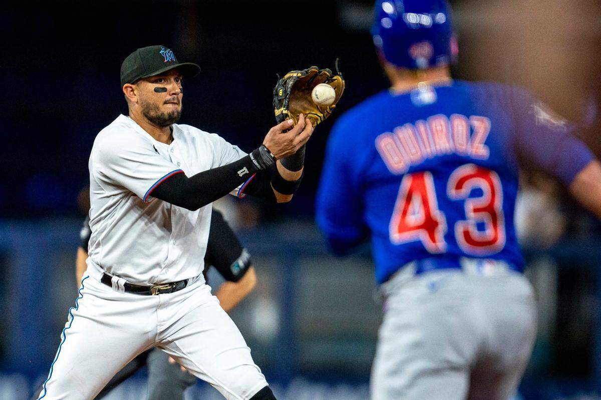 Miami Marlins short stop Miguel Rojas (11) catches the ball before throwing to first base for the double play during the first inning of an MLB game against the Chicago Cubs at loanDepot park in the Little Havana neighborhood of Miami, Florida, on Tuesday, September 20, 2022.