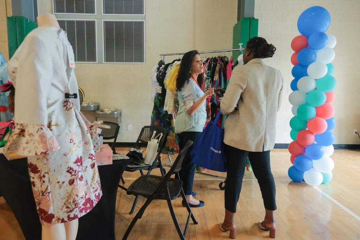 Cecilia Orrero, a manager at the clothing store Dress U For Less located in North Miami, speaks to a client during the City of North Miami District 4 Small Business Expo at the Joe Celestin Center at 1525 NW 135th St. in North Miami, Florida, Friday, August 22, 2025.