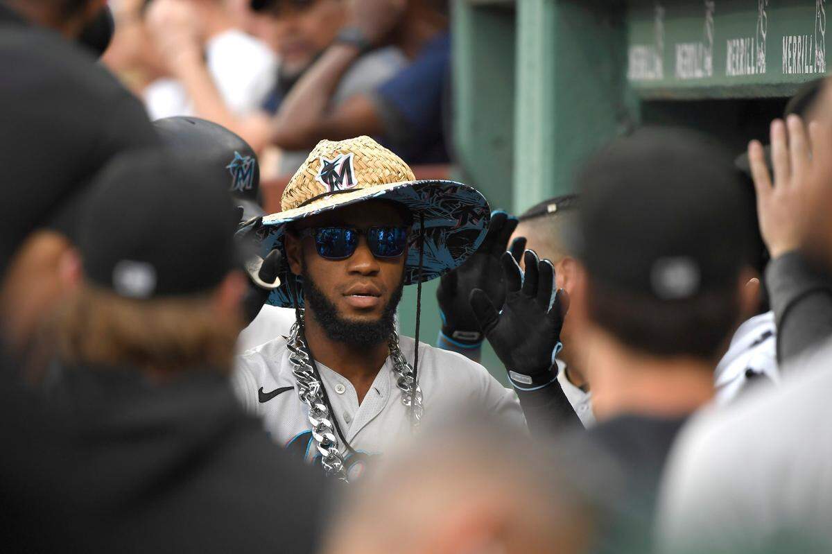 Miami Marlins left fielder Bryan De La Cruz (14) is greeted in the dugout after hitting a two run home run during the first inning against the Boston Red Sox at Fenway Park.