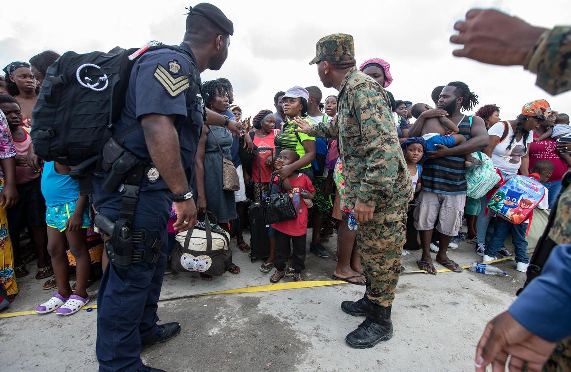 Royal Bahamas Defense Forces and Royal Bahamas Police help evacuees gathered at Marsh Harbour Port in Abaco on Friday, Sept. 6, 2019, waiting to leave the island after Hurricane Dorian swept through the Bahamas.