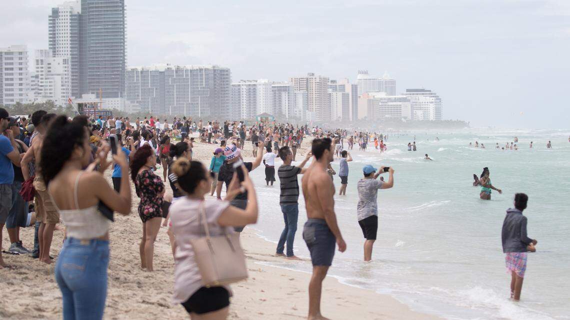 People enjoy the Hyundai Air & Sea Show during one of the brief breaks in the rain in Miami Beach on Sunday, May 27, 2018.