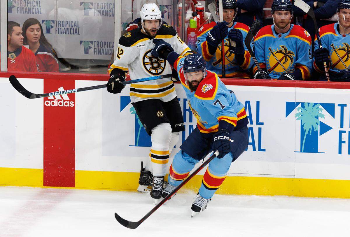 Florida Panthers defenseman Radko Gudas (7) push Boston Bruins center Craig Smith (12) during the first period of an NHL game at FLA Live Arena on Wednesday, November 23, 2022 in Sunrise, Fl.