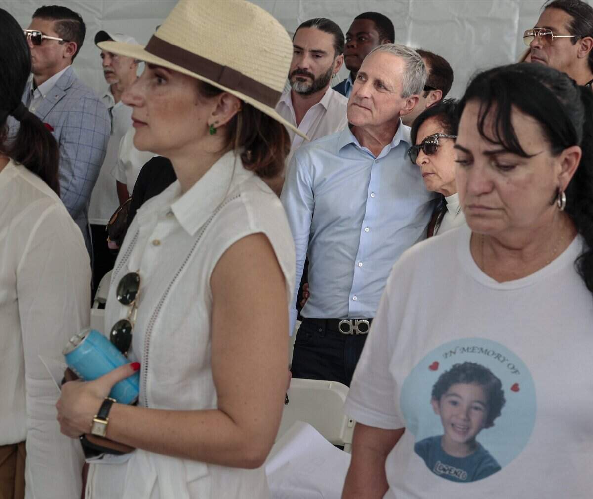 Pablo Langesfeld, left, and his wife, Andrea Langesfeld, right, embrace during a moment of silence for their daughter and son-in-law, who died in the Champlain Towers South collapse. Families and friends of other victims join in the remembrance.The Town of Surfside held its fifth annual Remembrance event on Wednesday, June 24, 2026, honoring the 98 people killed in the Champlain Towers South building collapse in Surfside, Florida.