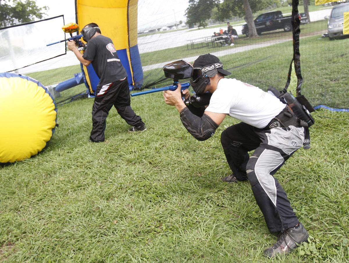 Mobile Paintball Entertainment’s Omel Ramirez and Jazz Avila line up their shots at a Mobile Paintball game in Miami’s Bicentennial Park in this Sept. 29, 2007, file photo.