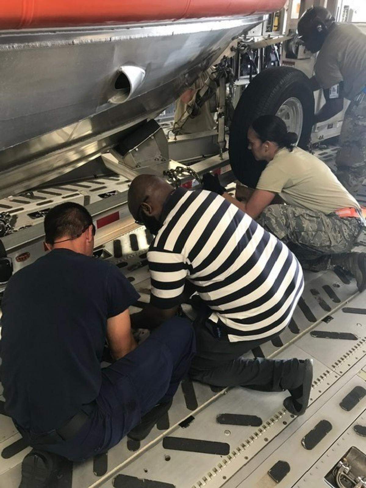 Coast Guard Petty Officer 2nd Class Arthur Andrade works with the Joint Air Mobility Team to secure the 29-foot Response Boat-Small in the Air Force C-17 Globemaster cargo airplane during Operation Patriot Sands at Homestead Air Reserve Base, Feb. 23, 2019. Operation Patriot Sands is an annual Air Force exercise in which agencies learn to properly prepare equipment, resources, and assets for tactical air mobility. Coast Guard Photo by Ensign Phillip Atkinson.
