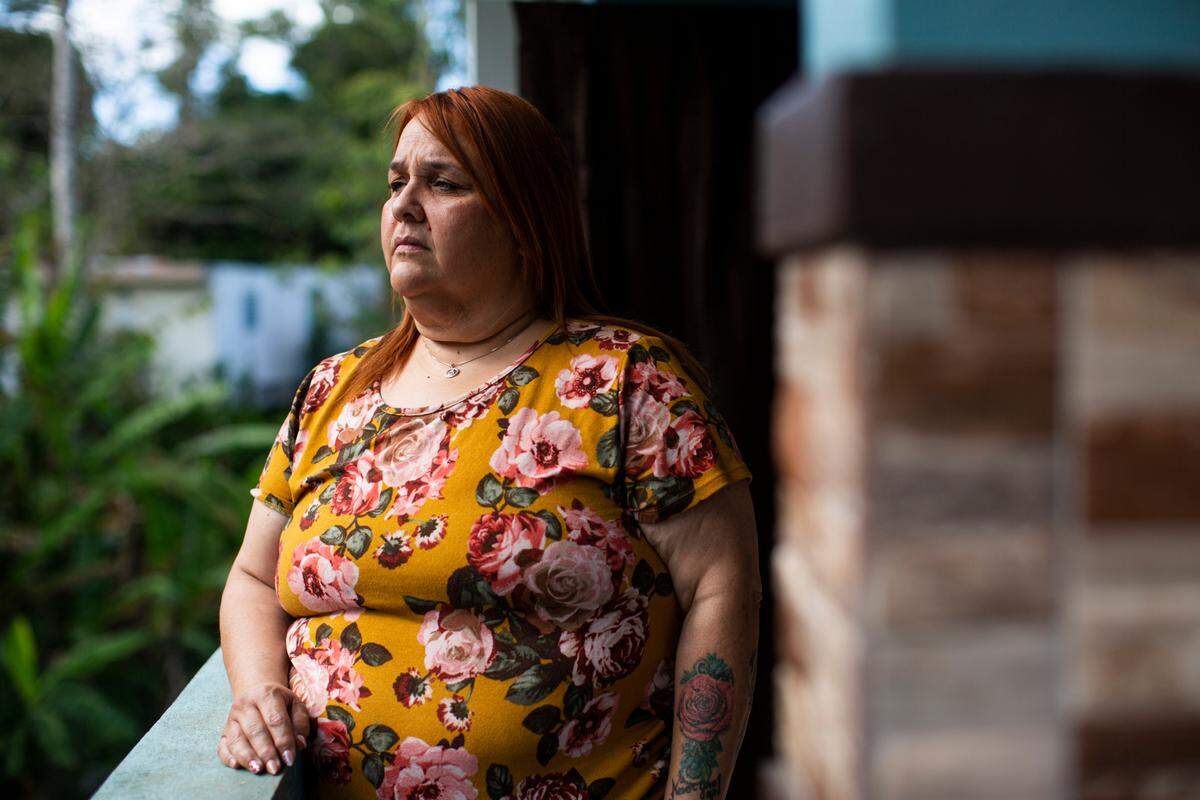 Elba Santos stands outside her house in Barranquitas, Puerto Rico, on March 21, 2021.