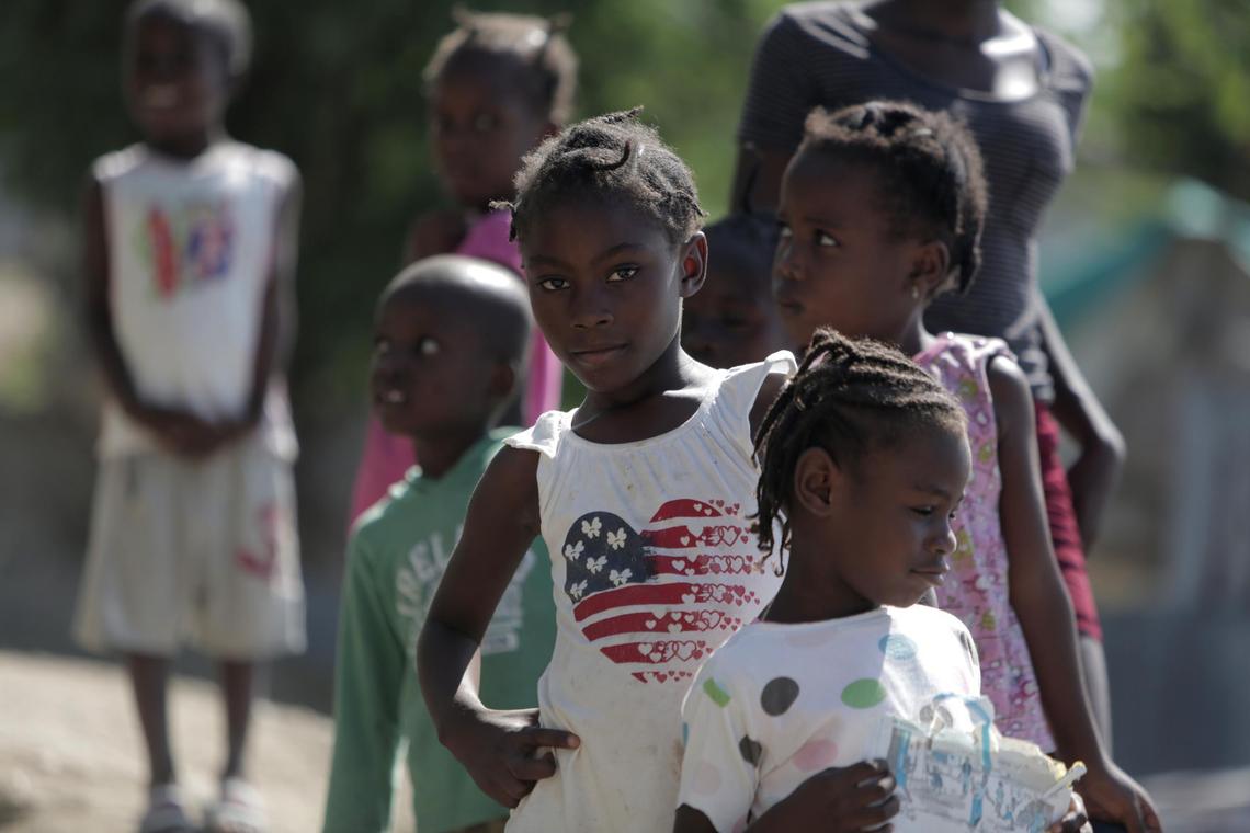 A group of children checks out visitors at the Teren Toto camp in Haiti.