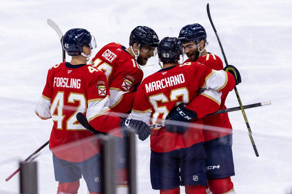 Florida Panthers teammates celebrate with left wing Brad Marchand (63) after he scored during the third period of an NHL game at Amerant Bank Arena against the Philadelphia Flyers on Thursday, October 9, 2025, in Sunrise, Fla.
