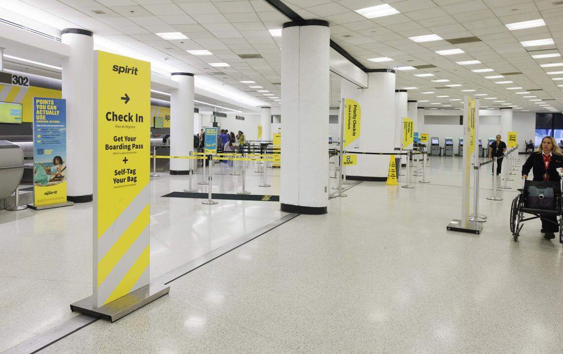 People check in to flights at a newly constructed Spirit ticketing pod during the day on Tuesday, Aug. 19, 2025, at the Miami International Airport in Miami, Fla.