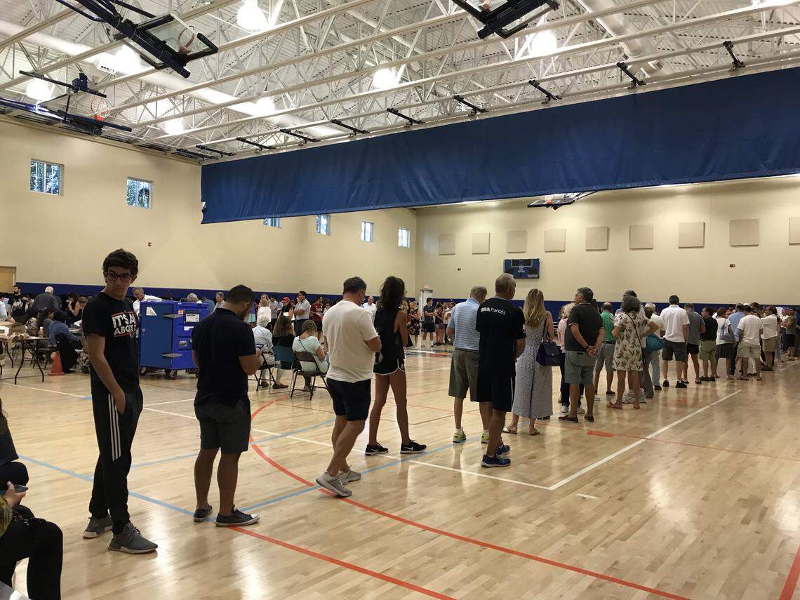Voters stand in line at the Key Biscayne Community Center gym, where some waited more than an hour to cast a ballot on Tuesday.