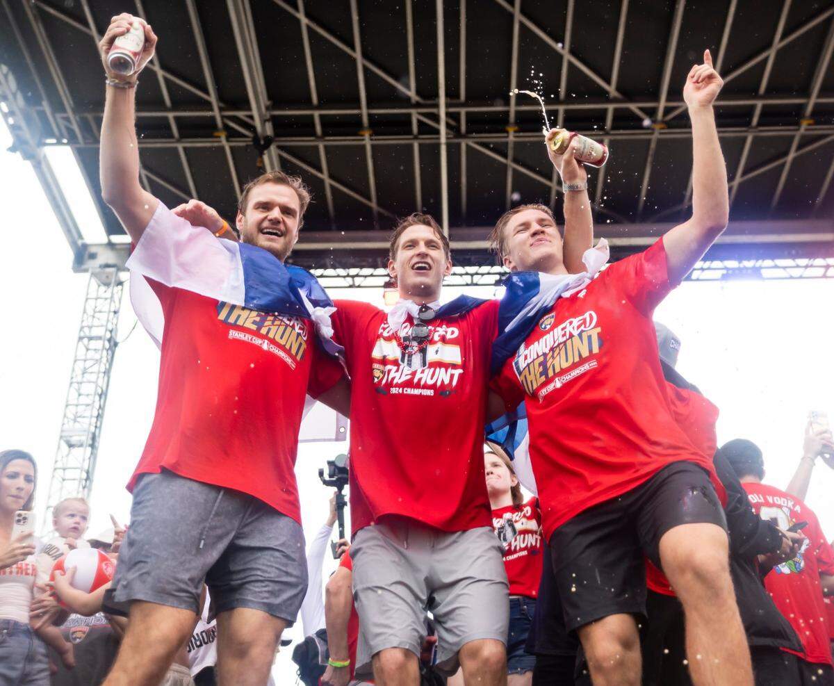 Florida Panthers centers Aleksander Barkov (16), Eetu Luostarinen (27) and Anton Lundell (15) celebrate on stage during a Stanley Cup victory parade rally at the Fort Lauderdale Beach Park off A1A on Sunday, June 30, 2024, in Fort Lauderdale, Fla. The parade was held to celebrate the Florida Panthers after they defeated the Edmonton Oilers in Game 7 of the Stanley Cup Final.