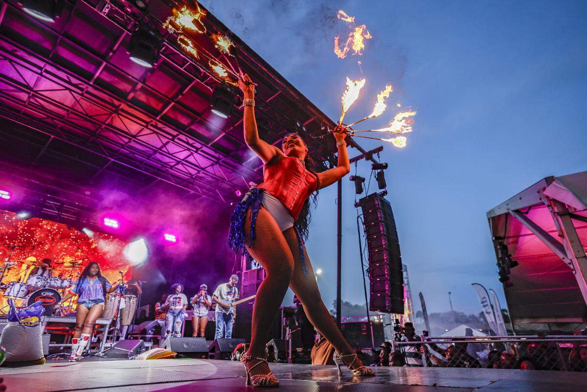 A fire dancer performs along with Haitian singer Anie Alerte  during the 28th Annual Haitian Compas Festival at The NoMI Village celebrating Haitian Flag Day, in North Miami, Florida  on Saturday, May 16, 2026.
